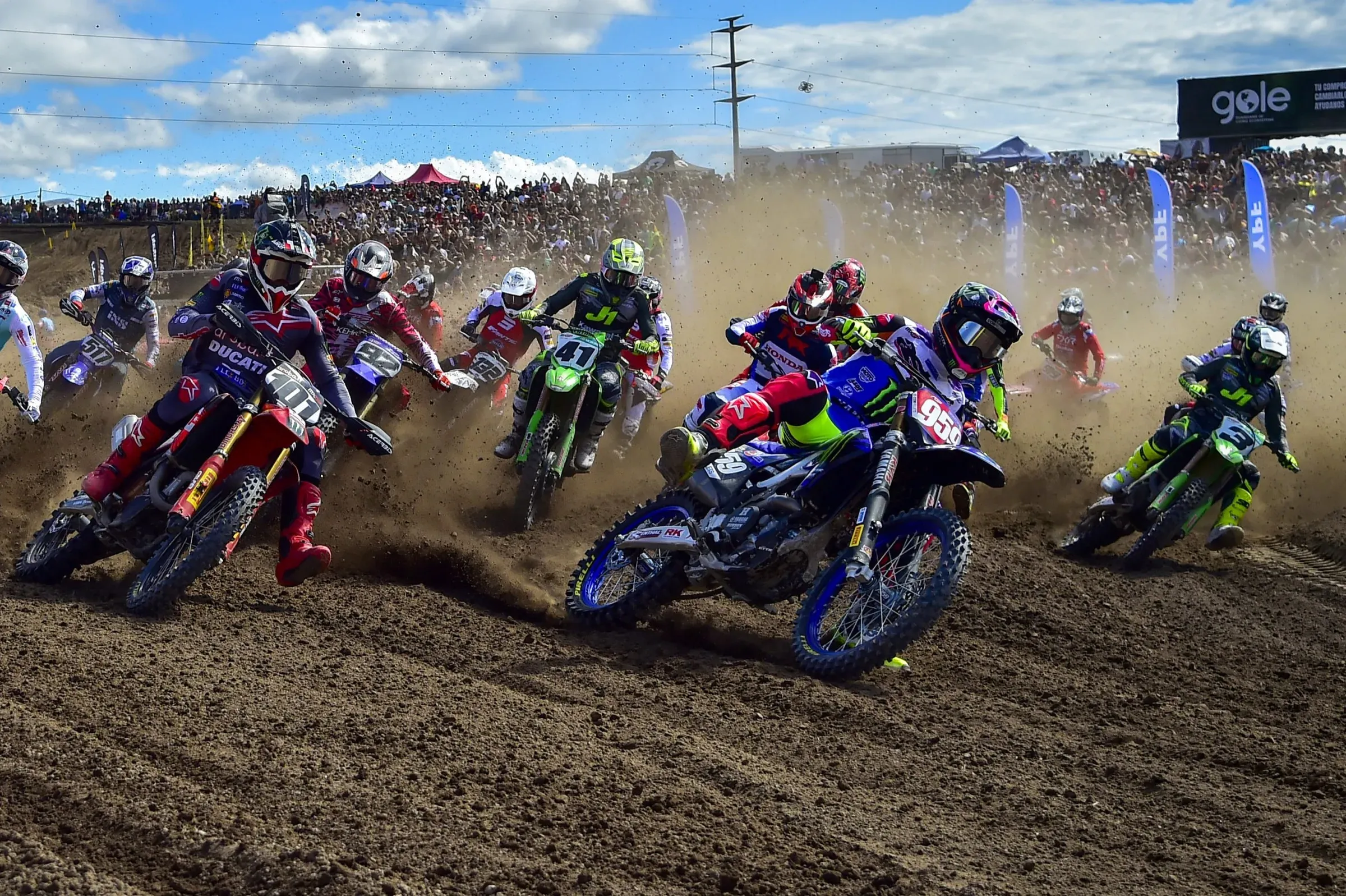 World Championship riders leaning into a sand corner at Almonte
